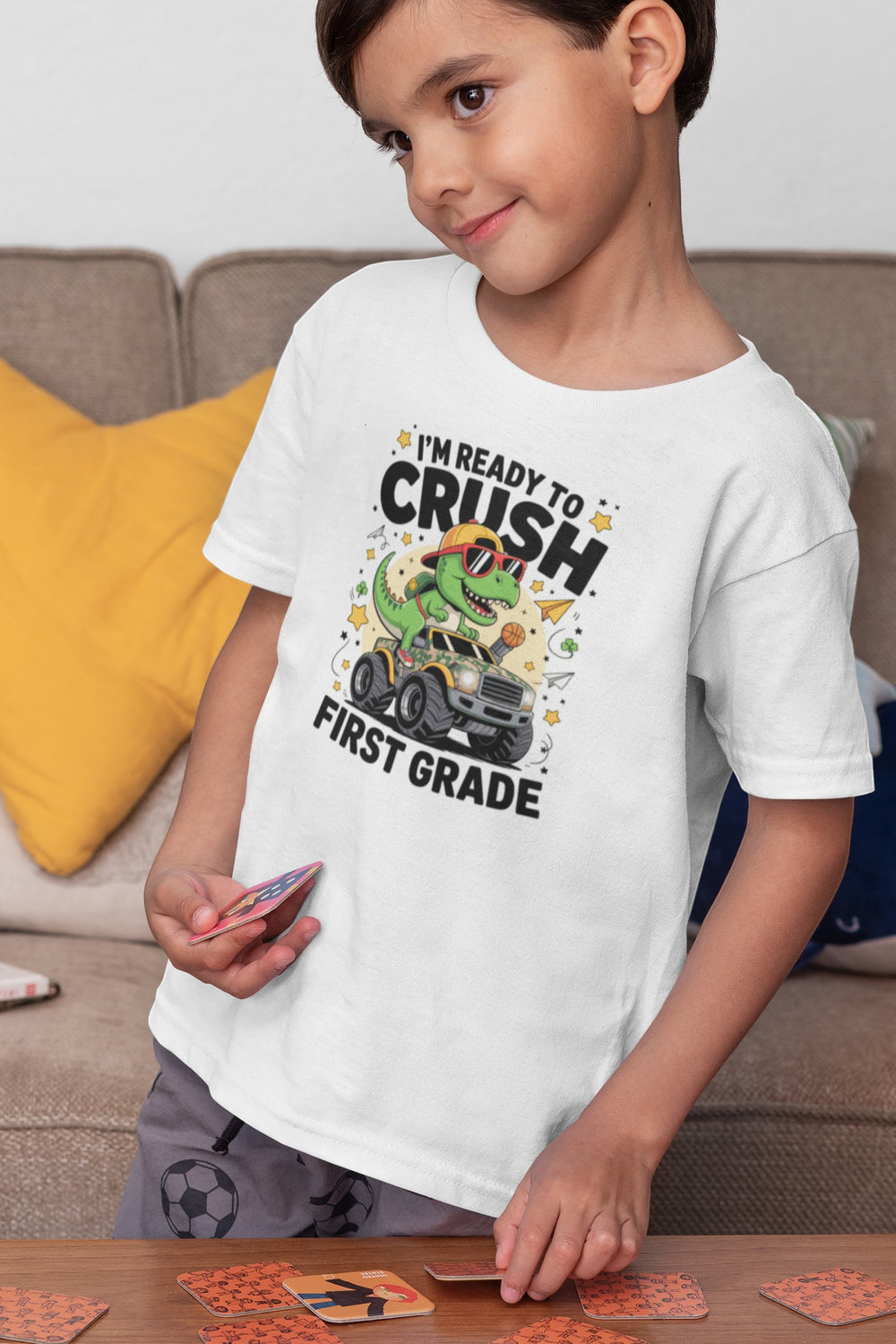 Sea Dragon Dreams white cotton youth t-shirt featuring a dinosaur monster truck graphic for first grade students.