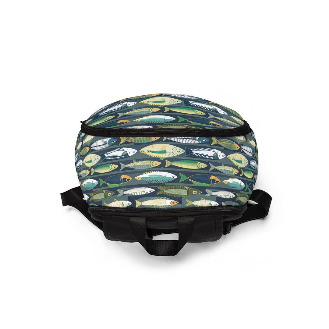 Sea Dragon Dreams unisex nylon backpack featuring a playful fish pattern on a dark background with adjustable straps.
