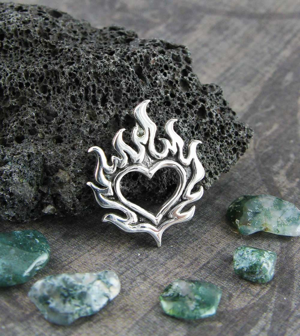 Sea Dragon Dreams handmade 925 sterling silver flaming heart pendant with oxidized details on a dark volcanic rock.