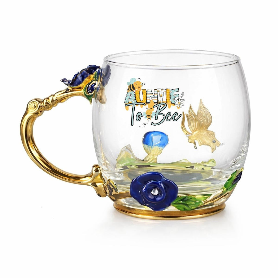 Sea Dragon Dreams Aunt to Bee glass mug with gold handle, floral enamel details, and coordinating spoon.
