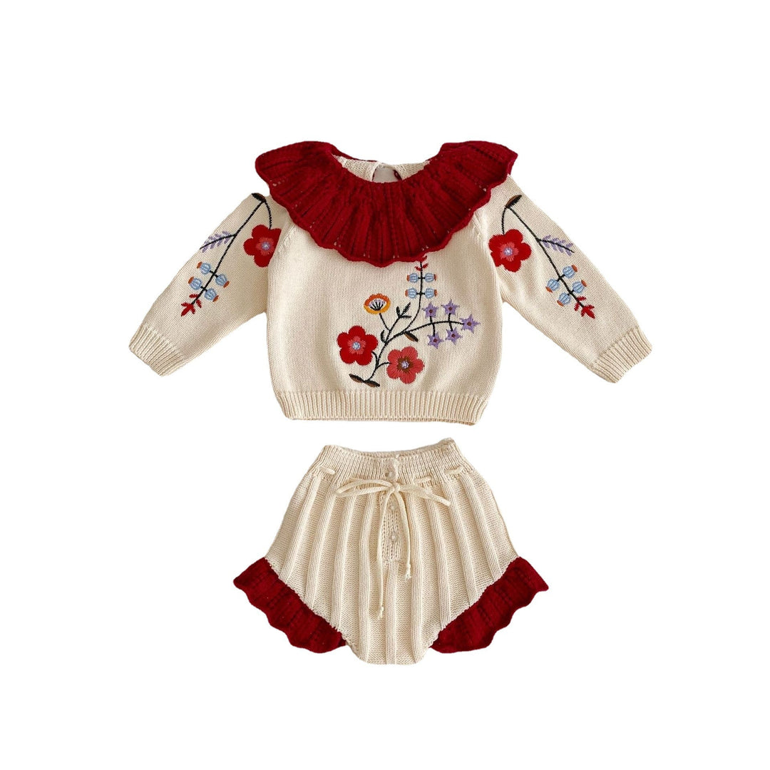 Sea Dragon Dreams baby girl knit set featuring an apricot-white floral blouse with a red ruffled collar and matching shorts