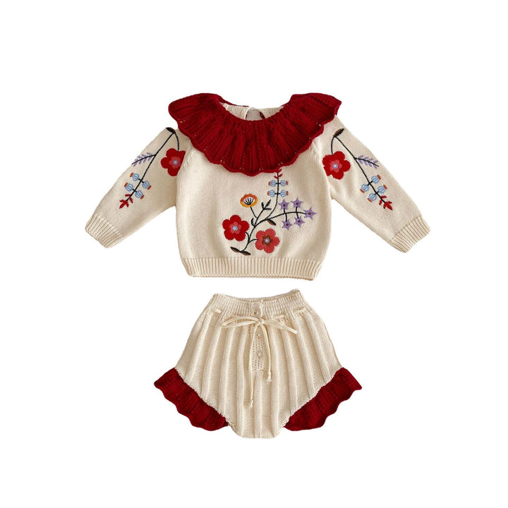 Sea Dragon Dreams baby girl knit set featuring an apricot-white floral blouse with a red ruffled collar and matching shorts