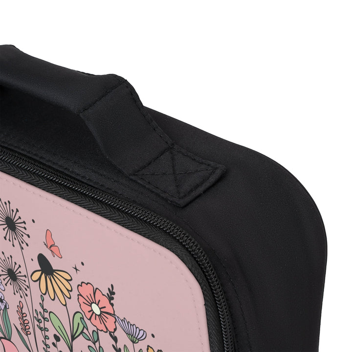 Sea Dragon Dreams lunch bag with floral print, black polyester fabric, zippered closure, and sturdy carrying handle.