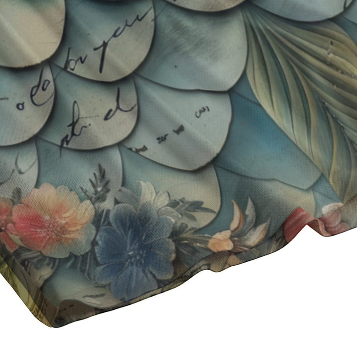 Sea Dragon Dreams swim shorts featuring a vintage floral and mermaid scale pattern in soft blue and muted tones.