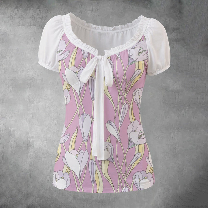 Sea Dragon Dreams floral print blouse with white puff sleeves, pleated neckline, and a front tie detail.
