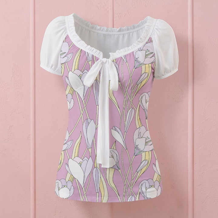 Sea Dragon Dreams floral print blouse with white puff sleeves, pleated neckline, and a front tie detail.