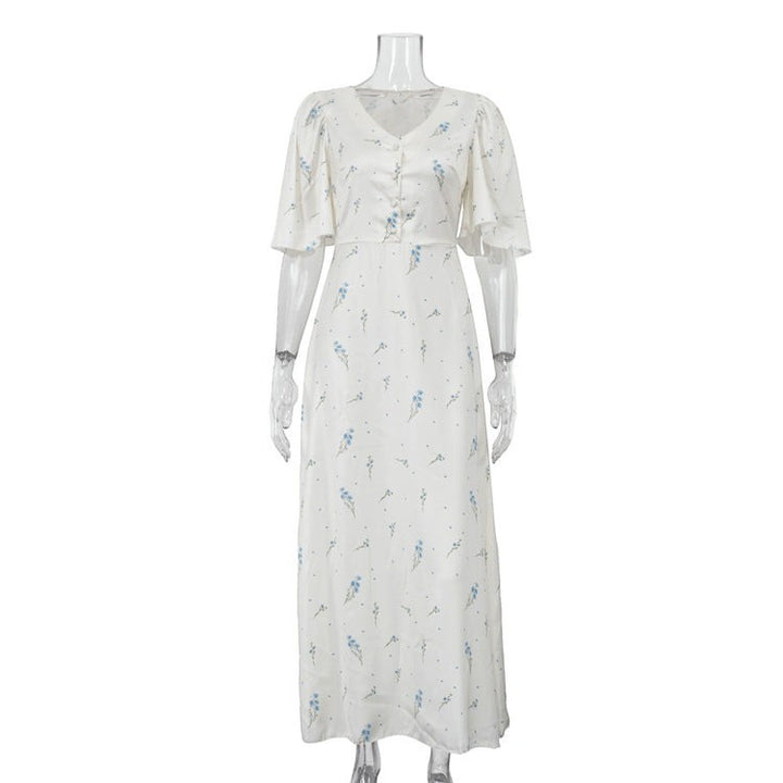 Sea Dragon Dreams white satin maxi dress with blue floral print, V-neckline, and flutter sleeves on a mannequin