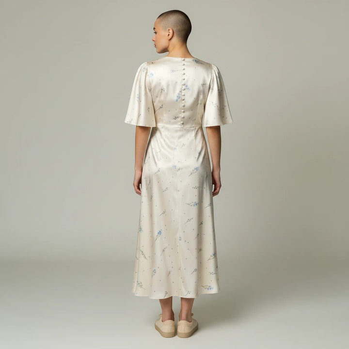 Sea Dragon Dreams floral satin maxi dress with short sleeves and button-back detail on a model, back view.