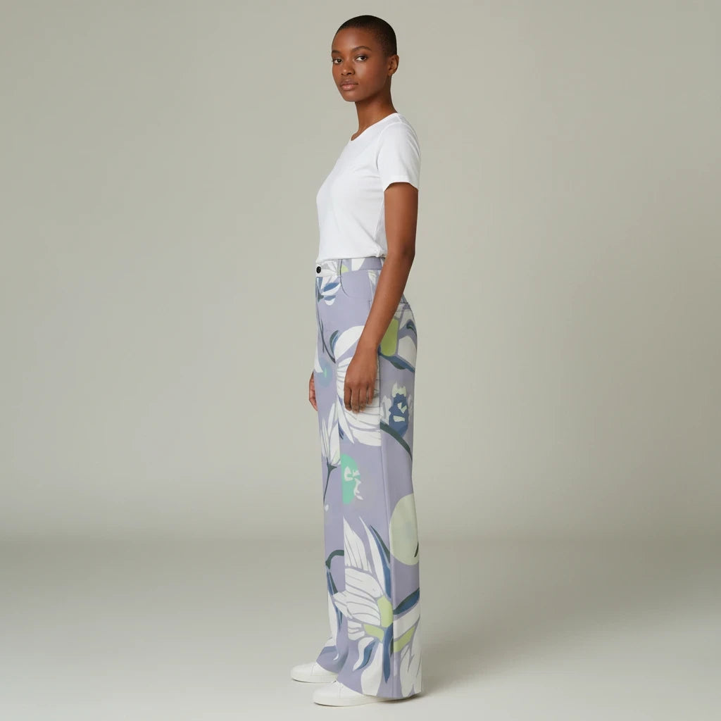 Sea Dragon Dreams high-waisted wide-leg pants in a light purple floral print, worn by a model with a white t-shirt.