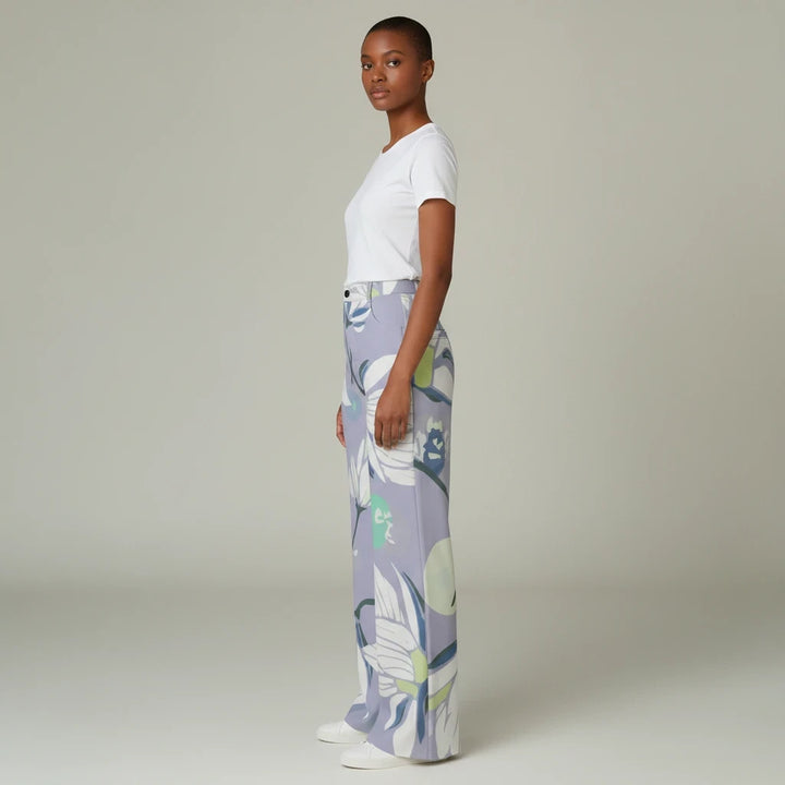 Sea Dragon Dreams high-waisted wide-leg pants in a light purple floral print, worn by a model with a white t-shirt.