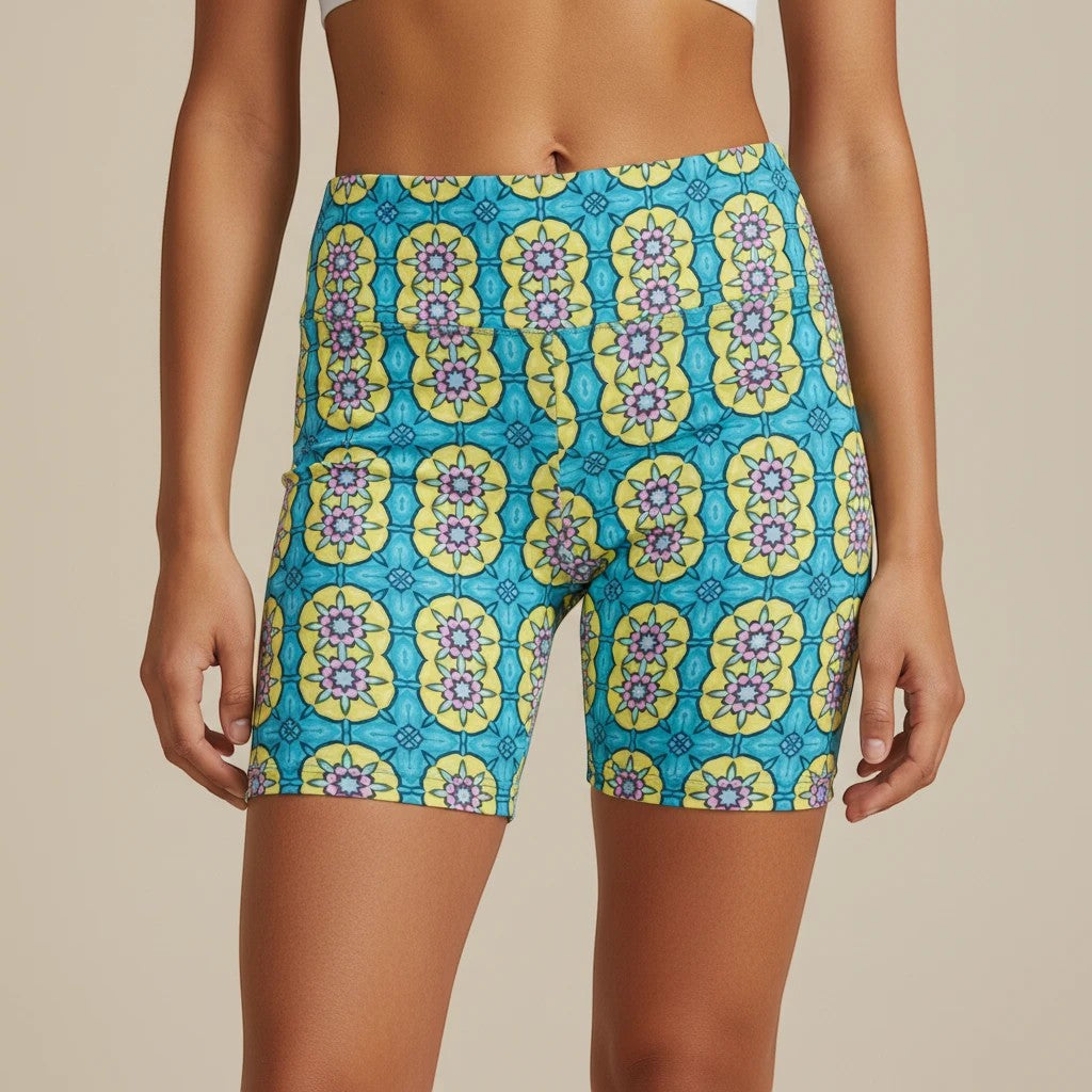 Sea Dragon Dreams women's workout shorts featuring a vibrant blue and yellow circle flower pattern in polyester.