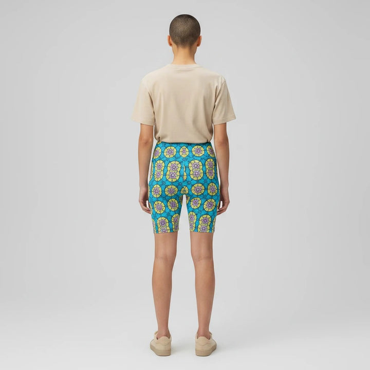 Back view of Sea Dragon Dreams women's workout shorts featuring a vibrant blue and yellow circle flower pattern.
