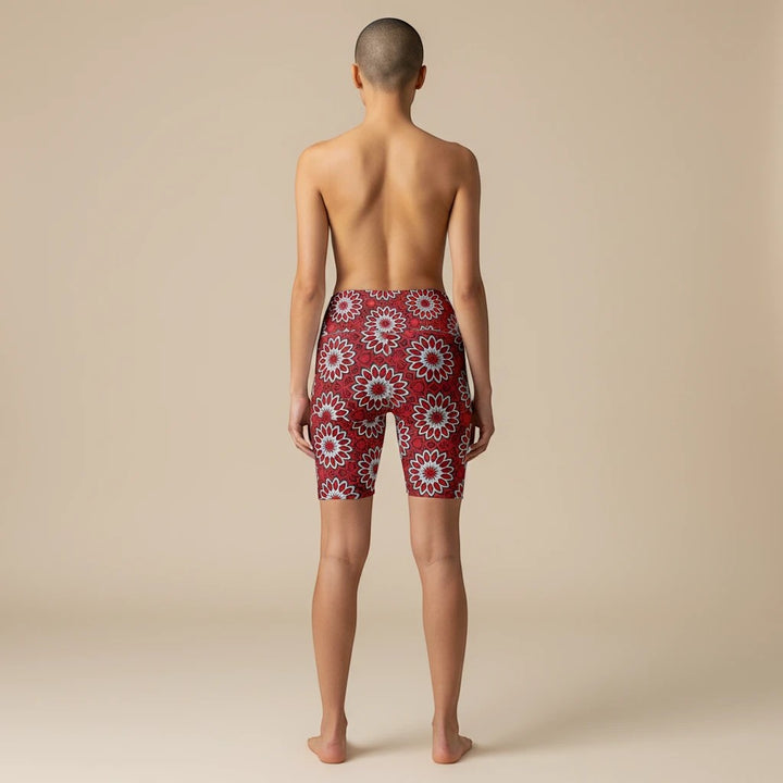 Back view of Sea Dragon Dreams Eternal Bloom workout shorts with a vibrant red and white floral pattern on a model.