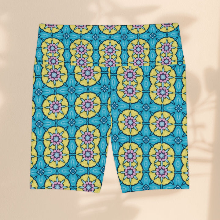 Sea Dragon Dreams women's workout shorts featuring a vibrant blue, yellow, and pink floral circle pattern.