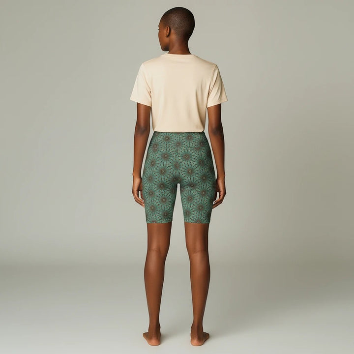 Back view of Sea Dragon Dreams floral workout shorts in green, worn with a beige t-shirt for yoga and fitness.