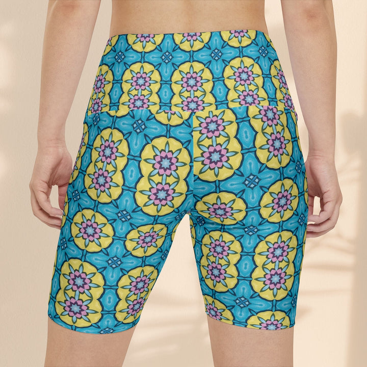 Sea Dragon Dreams women's workout shorts featuring a vibrant blue and yellow floral circle pattern in polyester.
