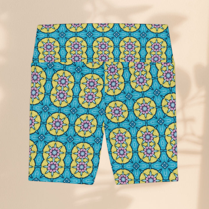 Sea Dragon Dreams women's workout shorts featuring a vibrant blue, yellow, and pink floral circle pattern.