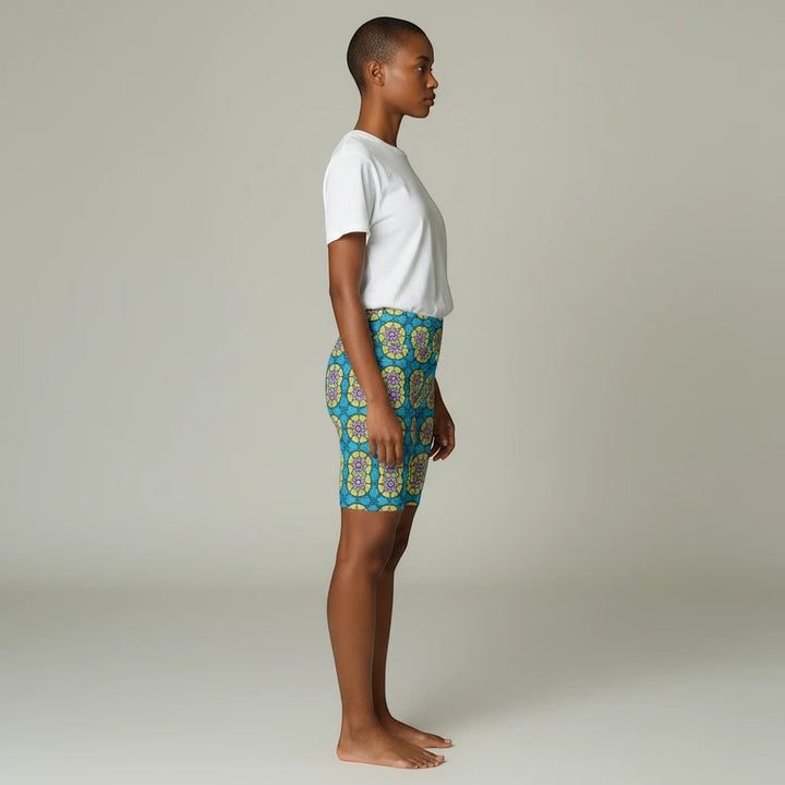 Sea Dragon Dreams women's workout shorts featuring a vibrant blue and yellow circle flower pattern on polyester fabric.
