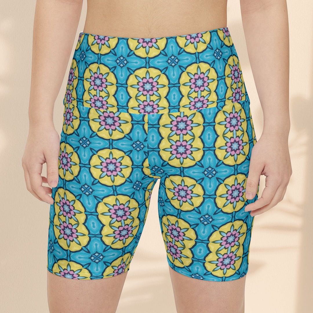 Sea Dragon Dreams women's workout shorts featuring a vibrant blue, yellow, and pink floral circle pattern.