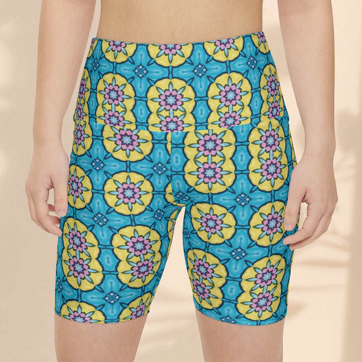 Sea Dragon Dreams women's workout shorts featuring a vibrant blue, yellow, and pink floral circle pattern.