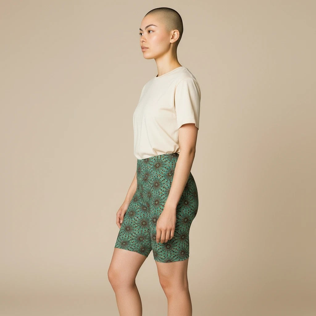 Sea Dragon Dreams floral print workout shorts in green, worn by a model with a neutral t-shirt for yoga and fitness.