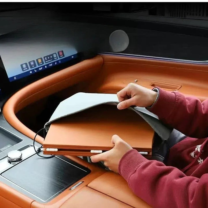 Sea Dragon Dreams folding car steering wheel table being unfolded inside a vehicle for use as a portable desk or tray.