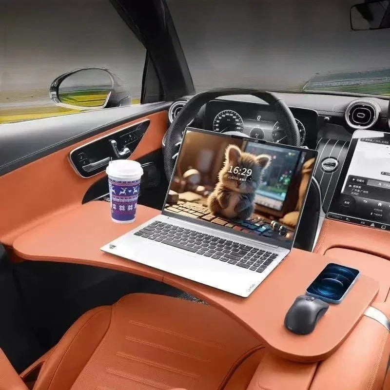 Sea Dragon Dreams folding car steering wheel table in tan, holding a laptop, coffee cup, and smartphone in a vehicle.