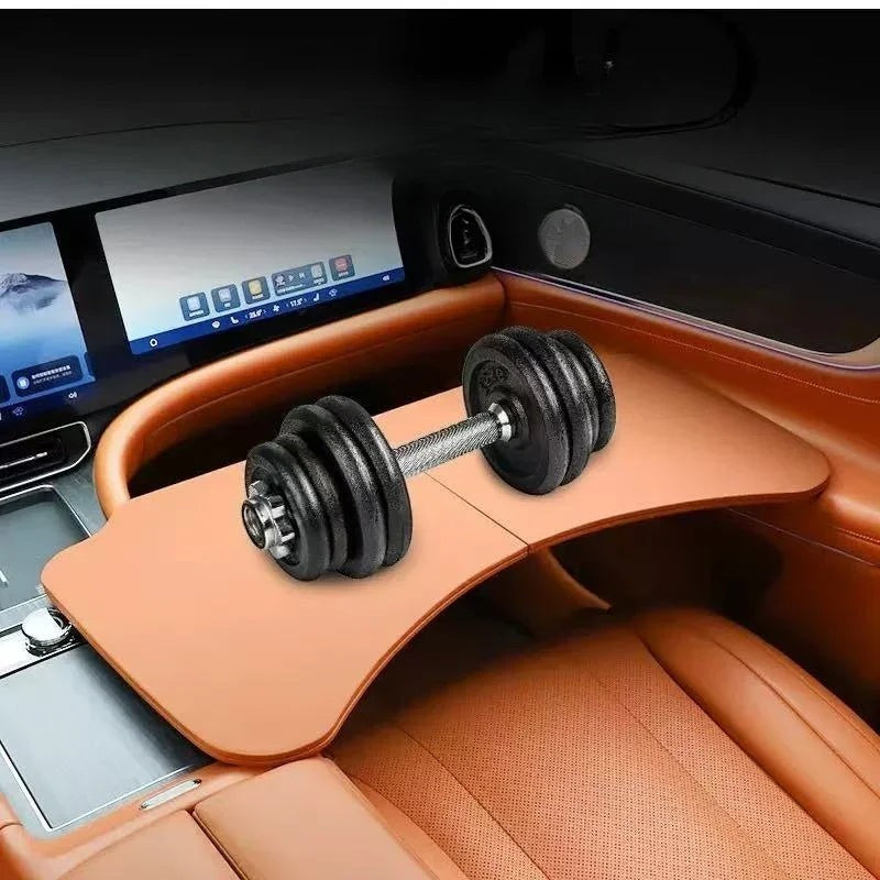 Sea Dragon Dreams folding car steering wheel table in tan, shown mounted in a vehicle with a dumbbell on top.