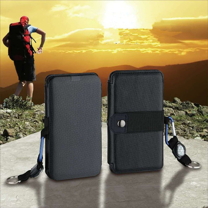 Sea Dragon Dreams portable folding solar panel charger in black, shown closed against a mountain sunset background.