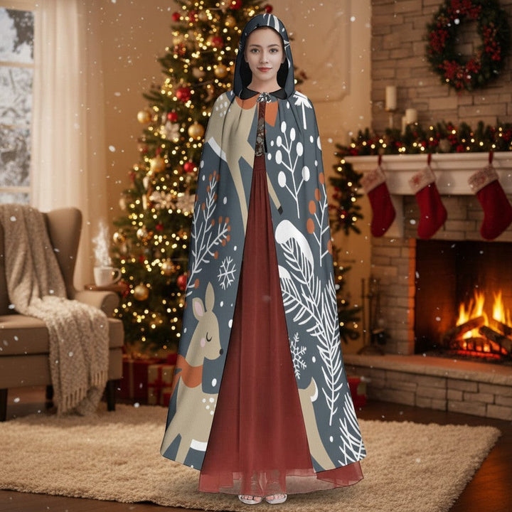 Sea Dragon Dreams unisex hooded cloak with enchanted forest deer print, worn by a woman in a festive holiday setting.