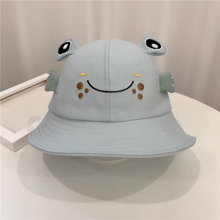 Sea Dragon Dreams light blue baby bucket hat featuring a cute embroidered frog face with 3D eyes and side fins