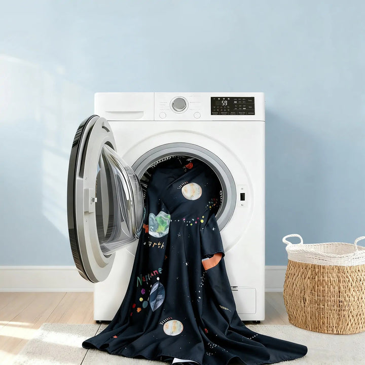 Sea Dragon Dreams galaxy-print kids bed tent fabric being washed in a white front-load washing machine