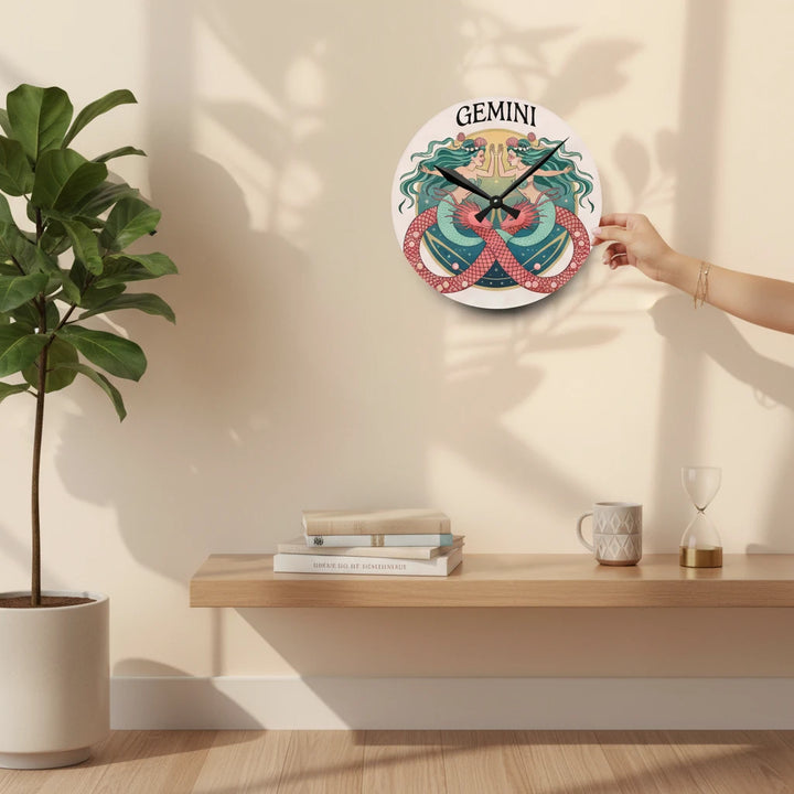 Sea Dragon Dreams round acrylic wall clock featuring a colorful Gemini twin mermaid illustration on a neutral wall.