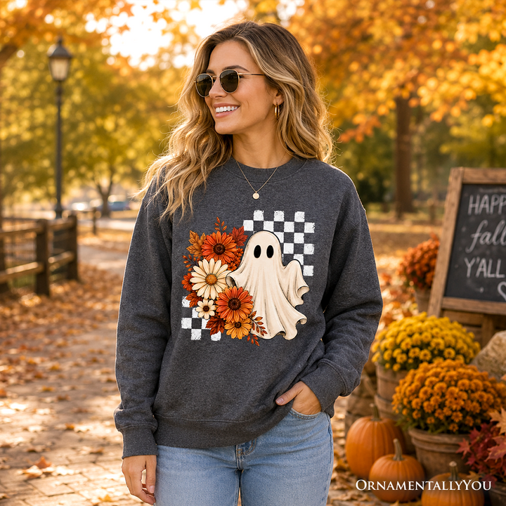 Sea Dragon Dreams charcoal grey sweatshirt featuring a ghost, checkered pattern, and fall flowers in a park setting.
