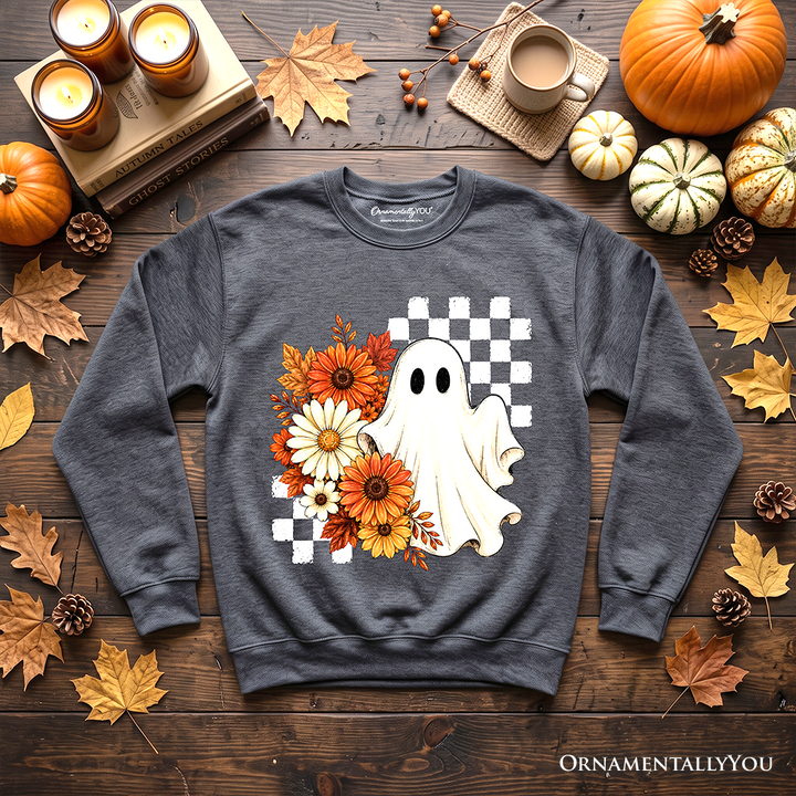 Sea Dragon Dreams charcoal grey sweatshirt featuring a ghost, checkered pattern, and fall flowers on a wooden table.