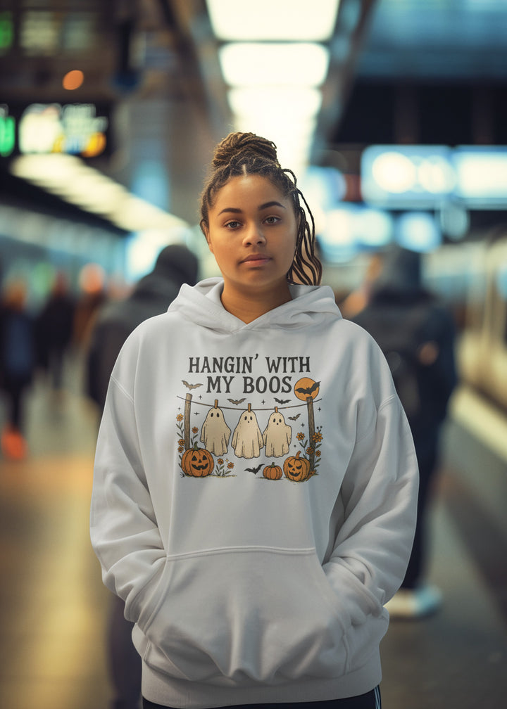 Sea Dragon Dreams white hooded sweatshirt with a Hanging With My Boos ghost and pumpkin graphic on a young woman