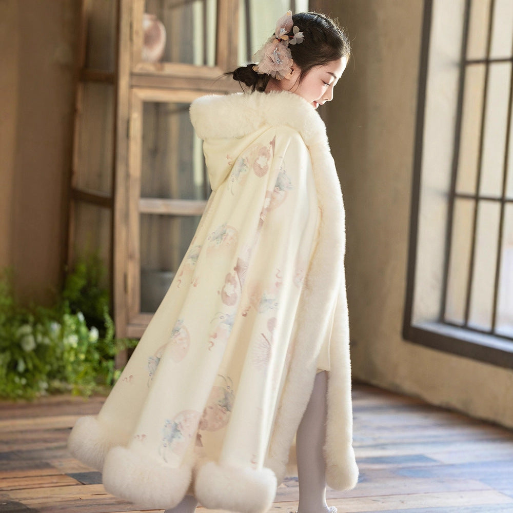 Sea Dragon Dreams girls' cream quilted velvet hooded cloak with faux fur trim worn by a child in a sunlit room