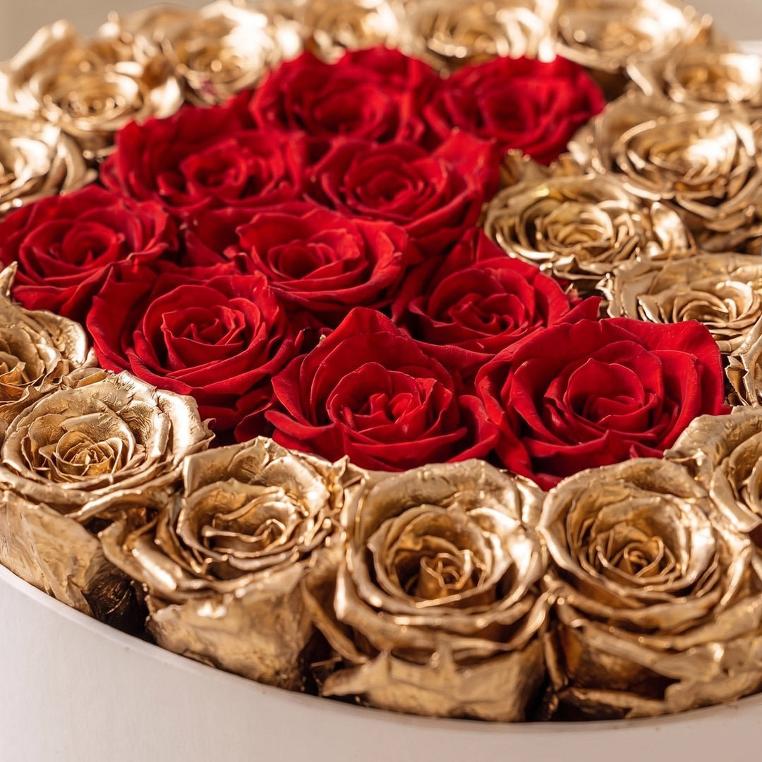 Sea Dragon Dreams heart-shaped white box filled with preserved red roses and metallic 24K gold roses for luxury gifting.