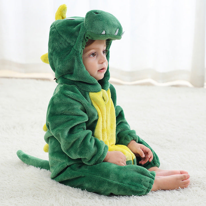 Sea Dragon Dreams green dragon onesie costume with a hooded character design, worn by a toddler on a white rug.