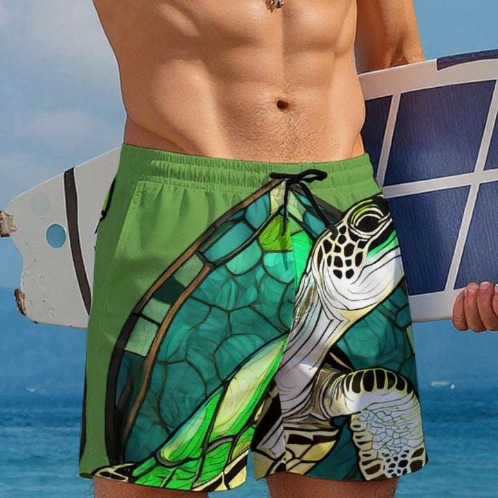 Sea Dragon Dreams men's green Hawaiian swim shorts featuring a sea turtle design, drawstring waist, and beach setting.