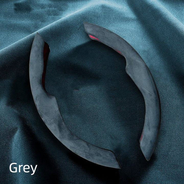 Sea Dragon Dreams grey Alcantara steering wheel cover segments for Tesla Model 3 and Model Y on a fabric background.