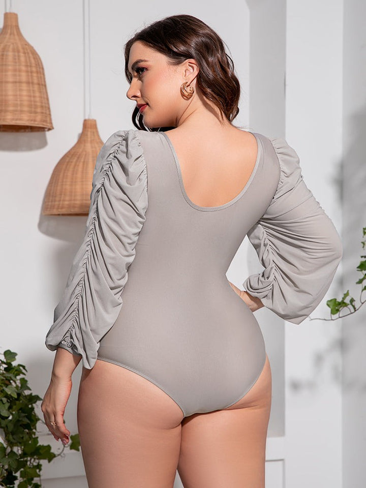 Sea Dragon Dreams plus size grey one-piece swimsuit with ruched balloon sleeves and a scoop back design.