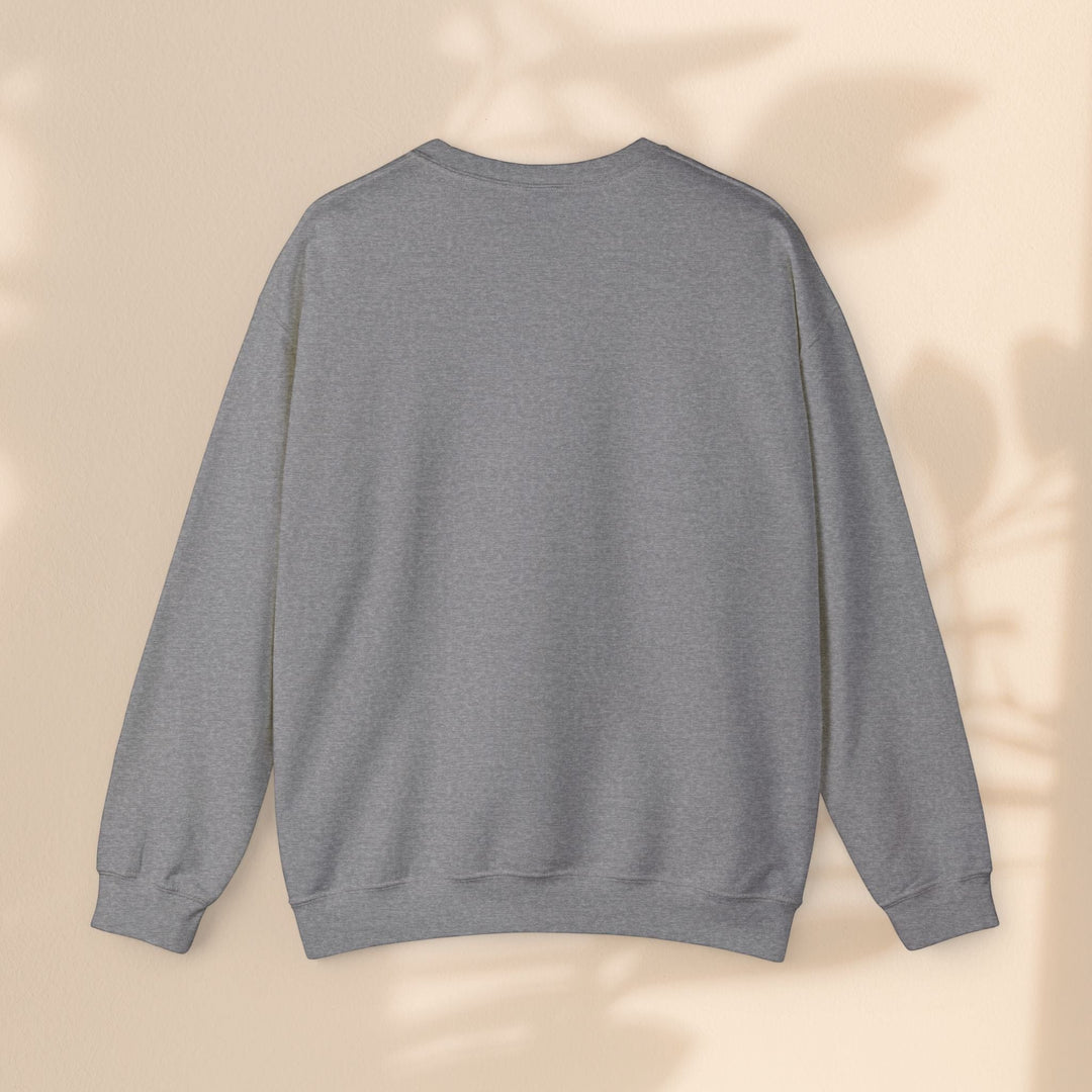 Sea Dragon Dreams grey unisex crewneck sweatshirt with long sleeves and ribbed cuffs against a neutral wall background
