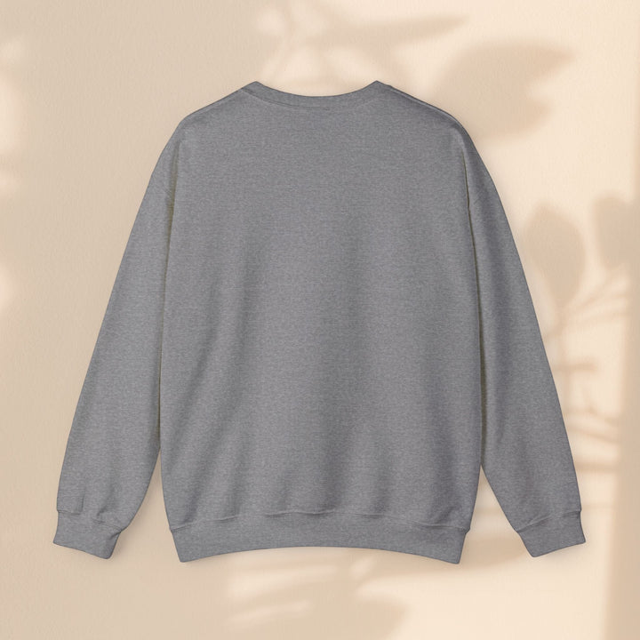 Sea Dragon Dreams grey unisex crewneck sweatshirt with long sleeves and ribbed cuffs against a neutral wall background