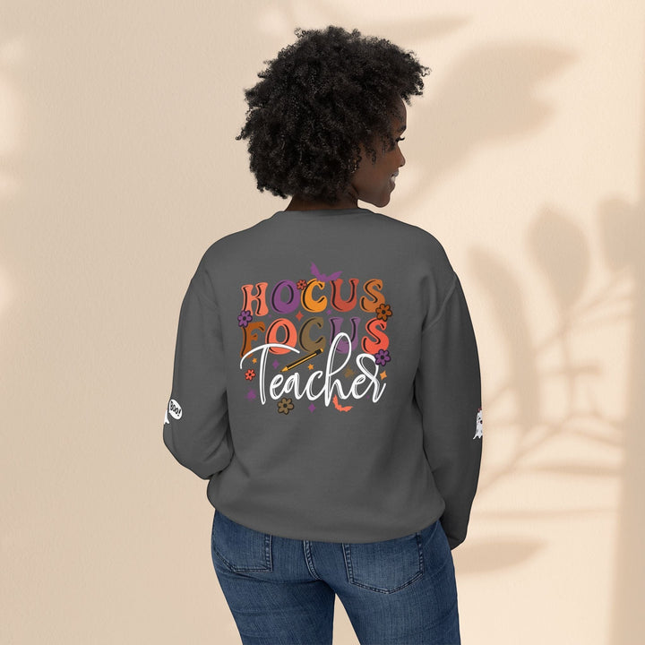 Sea Dragon Dreams grey crewneck sweatshirt with Hocus Focus Teacher Halloween graphic on back, worn by a woman.