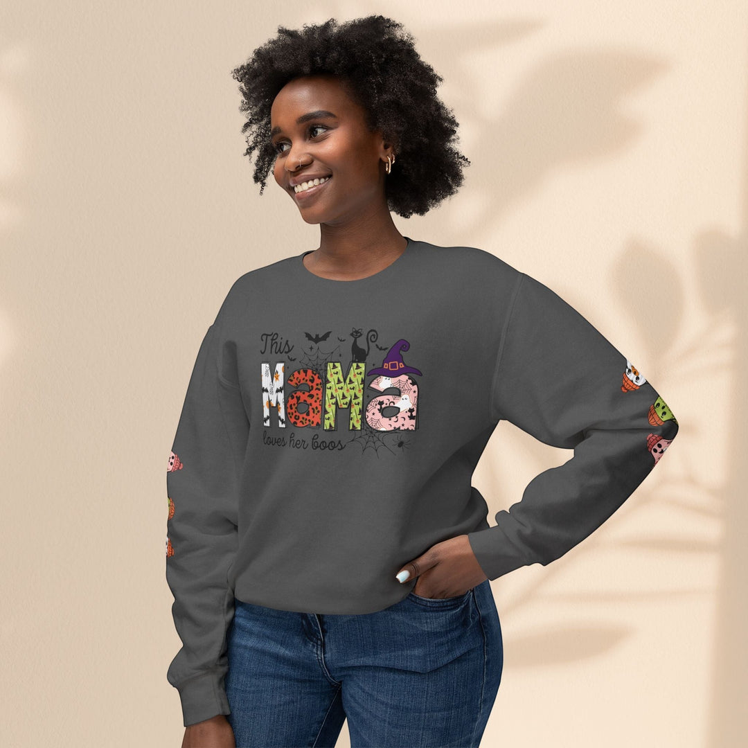 Sea Dragon Dreams grey crewneck sweatshirt with This Mama Loves Her Boos Halloween graphic worn by a smiling woman.