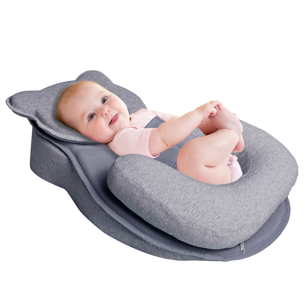 Sea Dragon Dreams grey inclined baby feeding pad with a baby lying comfortably and holding their feet