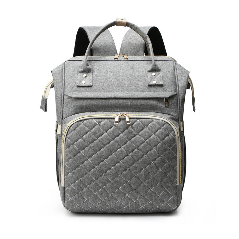 Sea Dragon Dreams grey quilted diaper backpack with gold zippers and spacious compartments for baby essentials