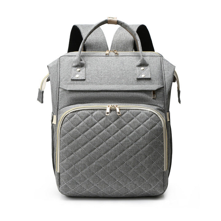 Sea Dragon Dreams grey quilted diaper backpack with gold zippers and spacious compartments for baby essentials