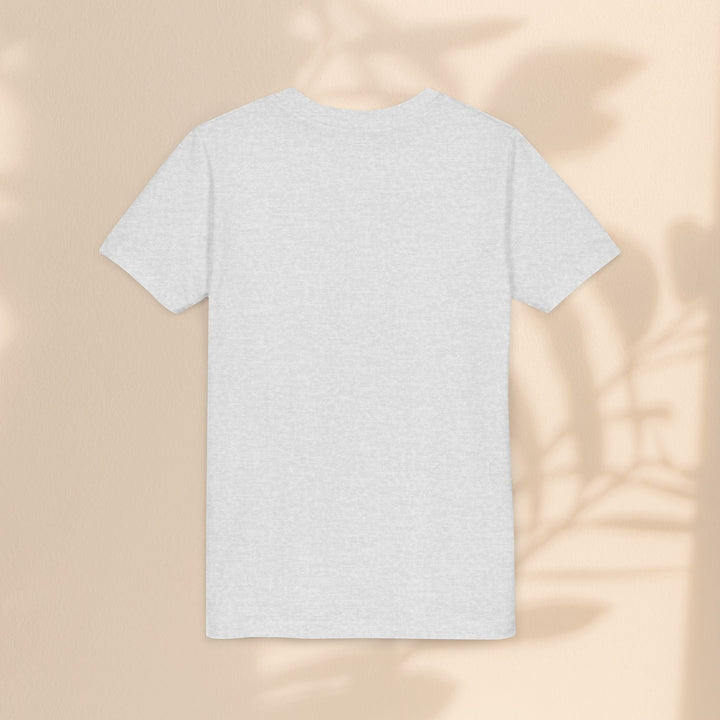 Sea Dragon Dreams back view of a plain light grey youth t-shirt on a beige background with leaf shadows.